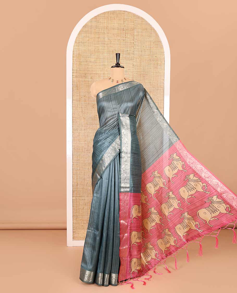 Blue striped semi-tussar saree, traditional zari border of floral creeper designs, contrast pallu of Pichwai cow print, and contrast Pichwai cow printed blouse