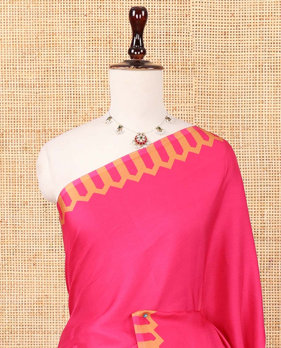 Rani pink plain gajji silk saree features a temple-printed border, a circular-shaped vine-patterned pallu, and a unique motif-printed blouse