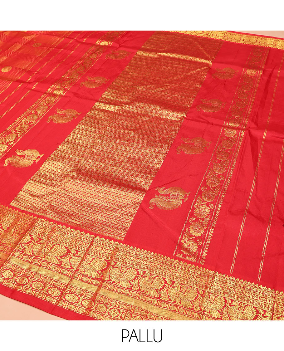 Red Kanchipuram Silk Saree, Gleamed Up with Mayil Butta Enclosed Checks, Highlighted by One-Sided Border of Thilakam Mokku, Kamalam, Mayil, Chakram, and Rudraksham Designs, Pallu of Chakram and Mayil Designs, and Comes Without a Blouse