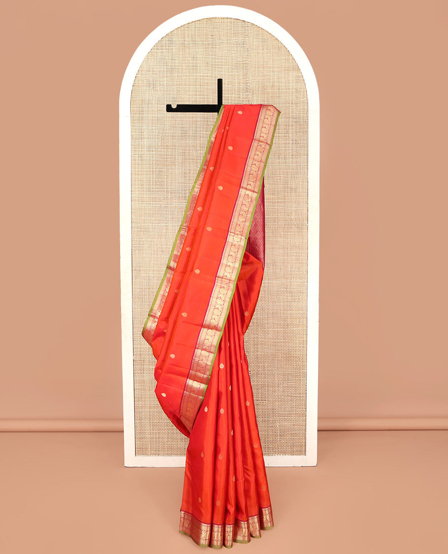 Orange Kanchipuram Silk Saree, Enthralled with Zari Buttas on Its Body, Complemented by a Contrast Border of Thilakam Mokku, Muthu, Mayil Kann, and Mayil Designs, Opulently Embellished Jaal Pallu, and Paired with a Contrast Blouse