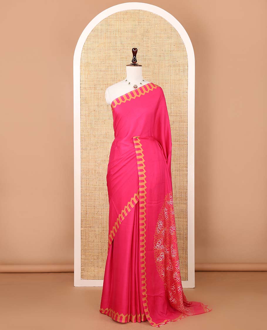 Rani pink plain gajji silk saree features a temple-printed border, a circular-shaped vine-patterned pallu, and a unique motif-printed blouse