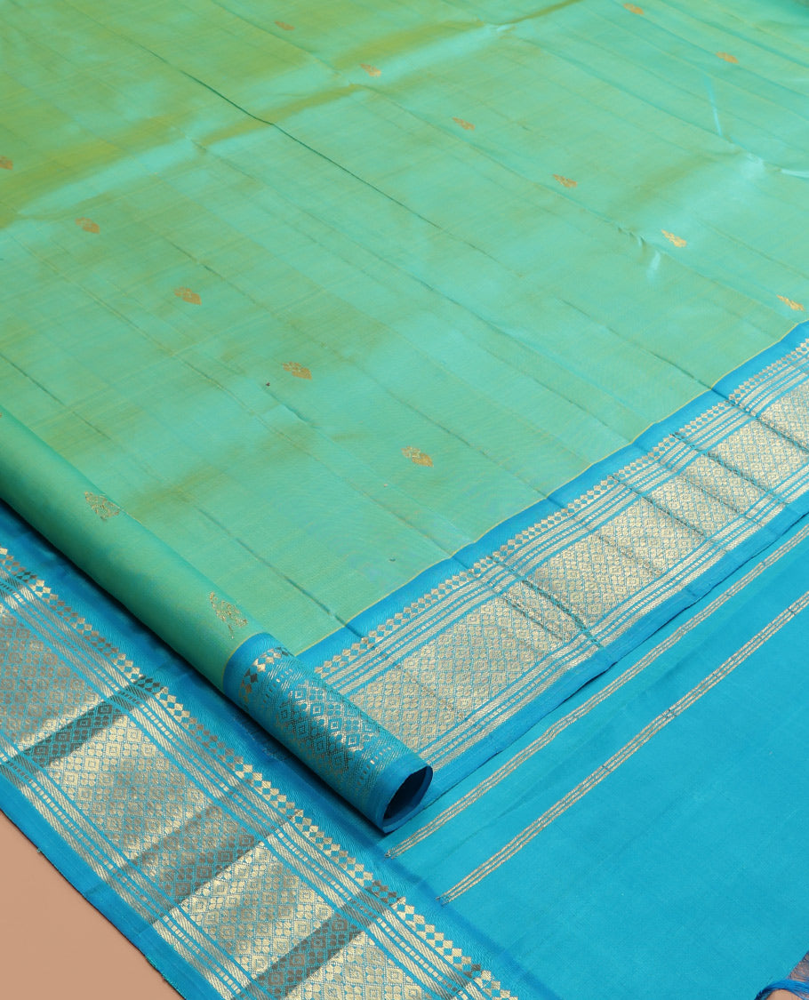 Turquoise Kanchipuram Silk Saree, Woven with Zari Buttas, a Contrast One-Sided Border of Panner Sombu, Banaras, Muthu, and Jaal Designs, Zari Design Pallu, and No Blouse