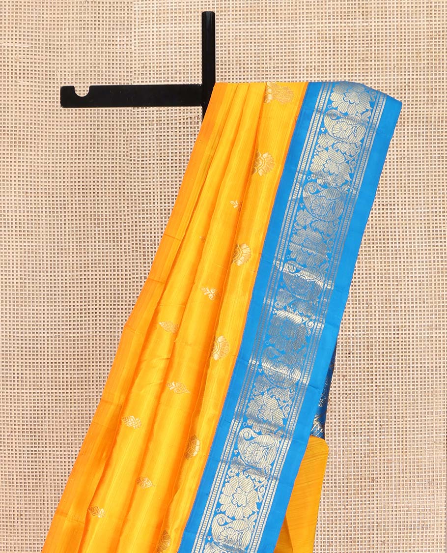 Yellow Kanchipuram Silk Saree, Ornamented with Zari Buttas on Its Body, Complemented by a Contrast One-Sided Korvai Border of Banaras, Muthu, Floral and Paisley Designs, Pallu of Intricate Designs, and Comes Without a Blouse