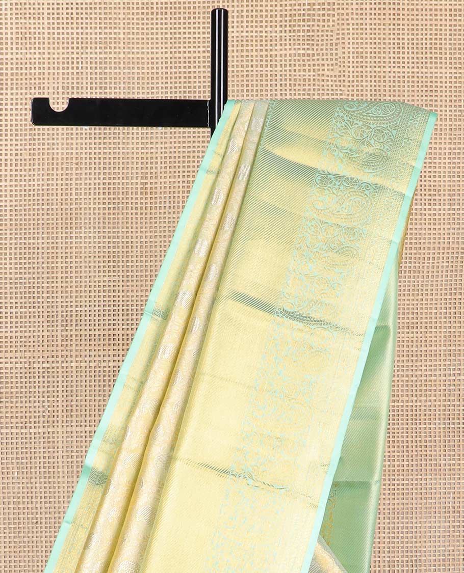 Mint green floral design kancheepuram tissue silk saree with contrast border of intricate zari design border & argyle design pallu