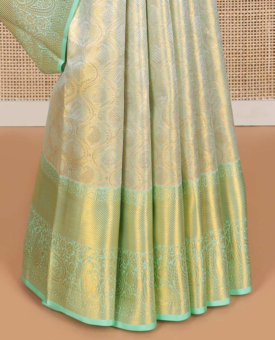 Mint green floral design kancheepuram tissue silk saree with contrast border of intricate zari design border & argyle design pallu