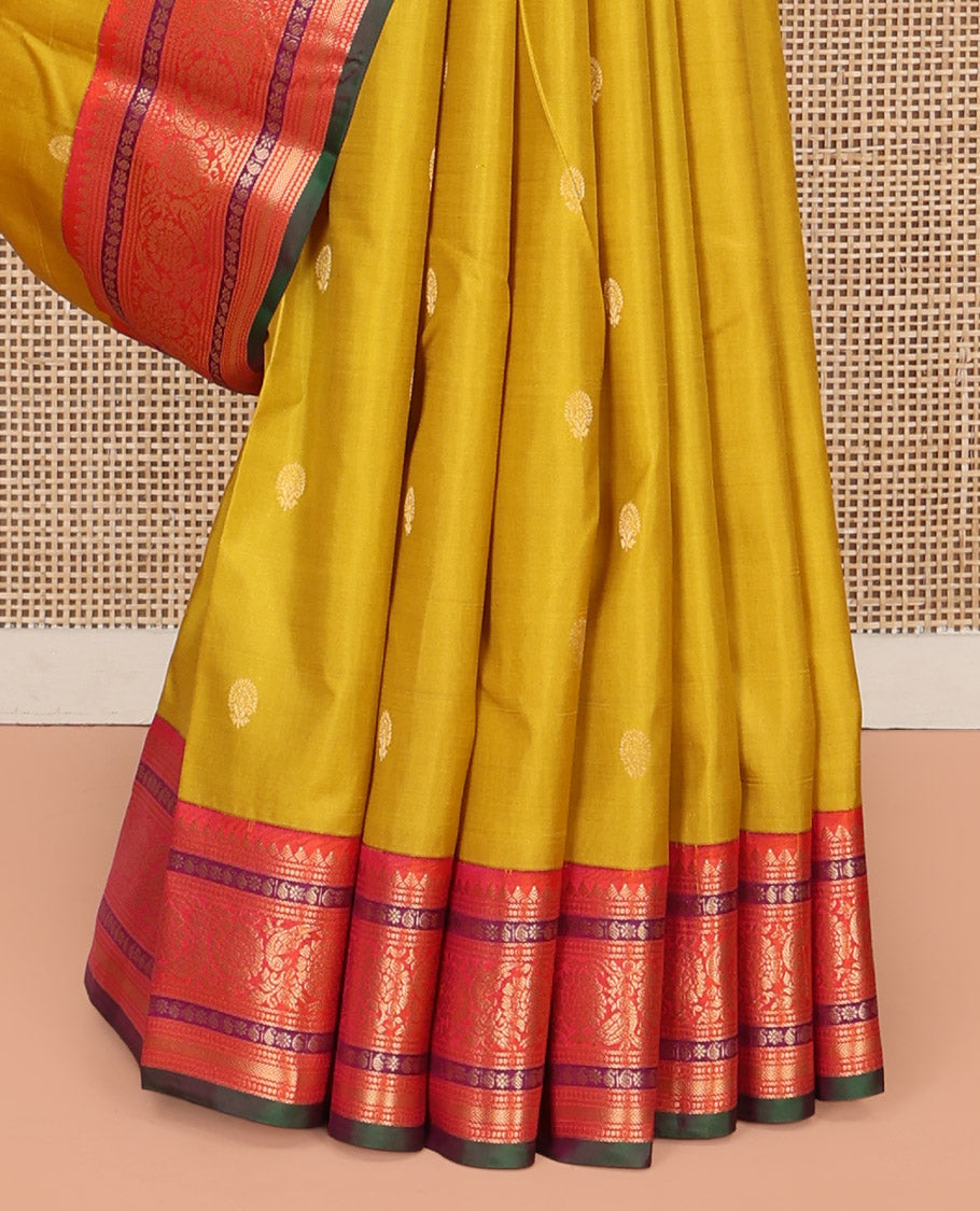 Yellow Vasundhara Silk Saree, Featuring Zari Buttas All Over Its Body, Complemented by a Contrast Border of Thilakam, Manga, Kamalam, Kathir, and Kodi Visiry Designs, Grand Jaal Pallu, and Paired with a Contrast Blouse