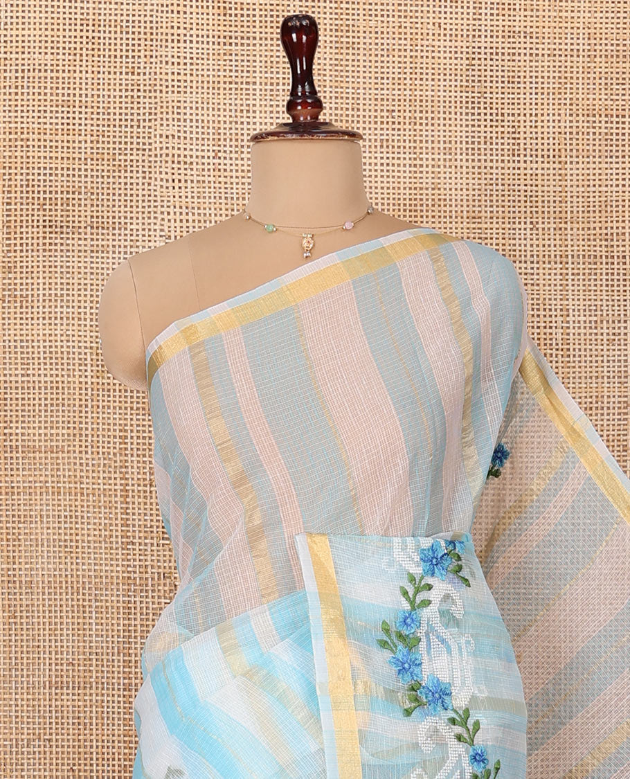 White and Blue Kota Cotton Saree, Adorned with Stripes and Floral Motifs Thread Embroidery on Its Body, Piping Border, Pallu Features Floral Embroidery, and Paired with a Matching Blouse
