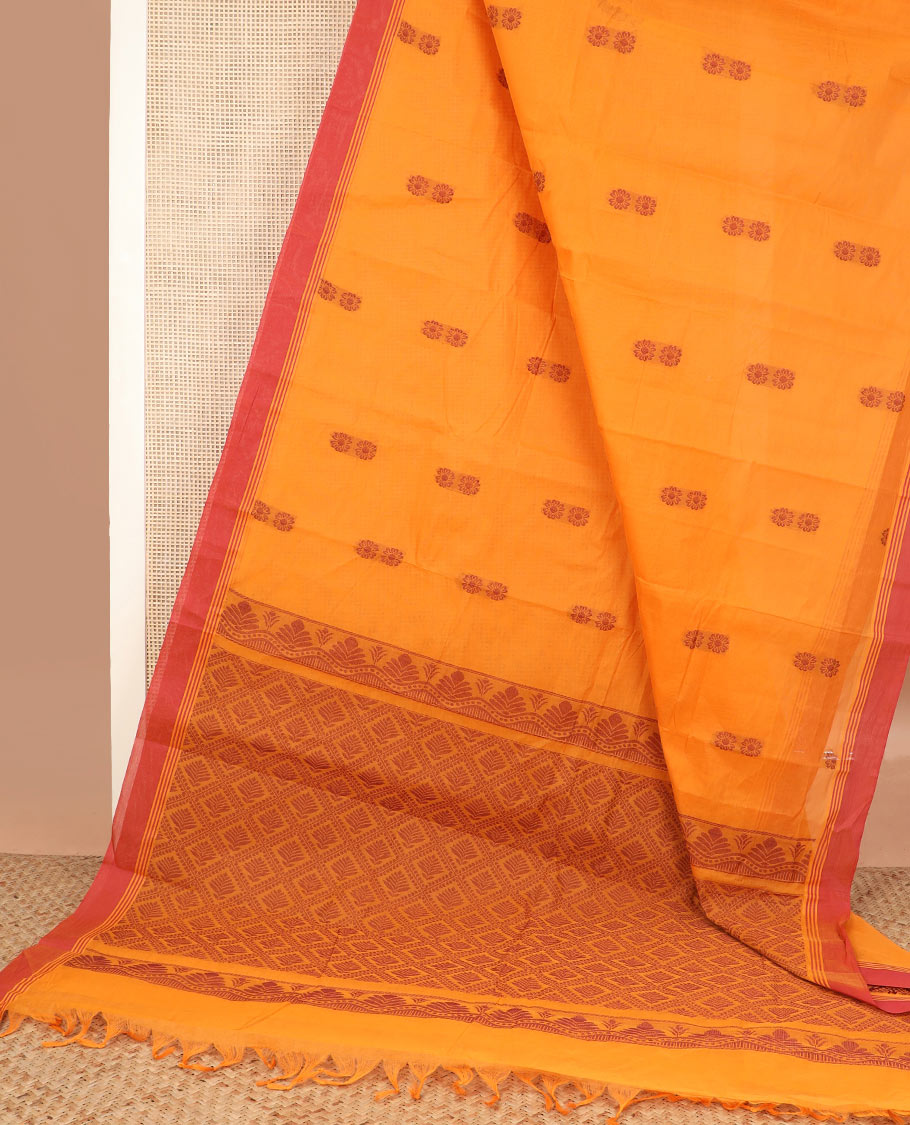 Orange floral buttas kanchi cotton saree, contrast plain border, and jaal pallu