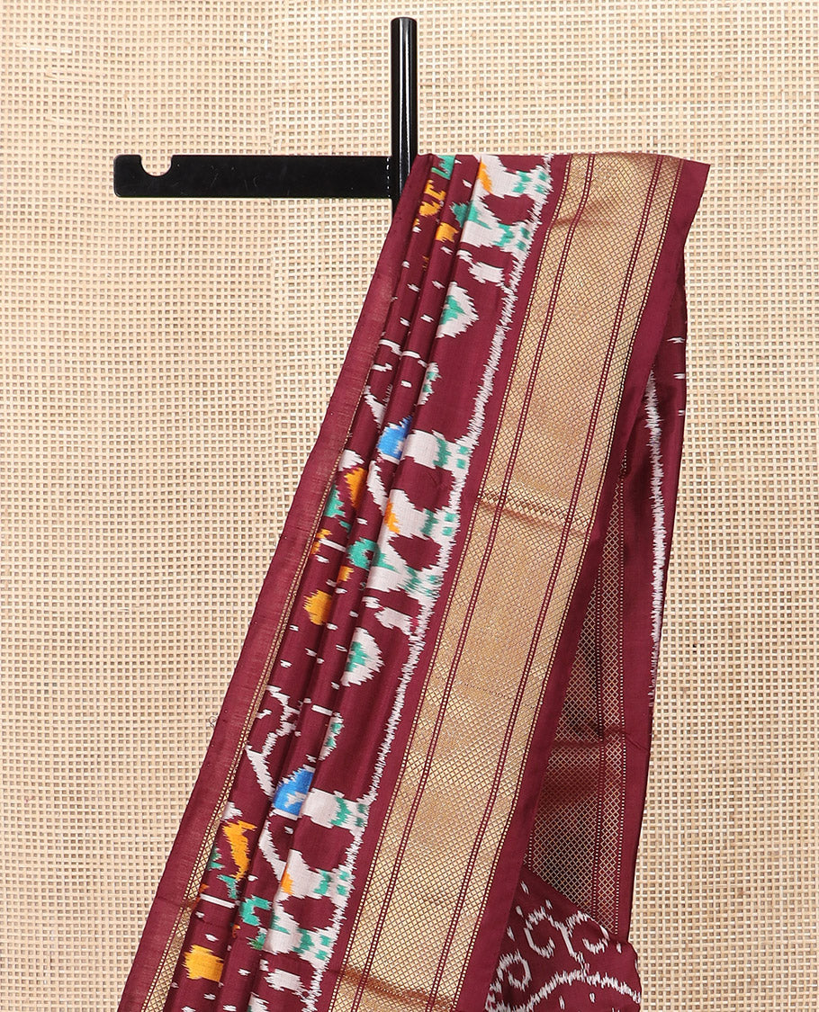 Maroon Ikkat Silk Saree with Colourful Elephant and Free-Style Ikkat Buttas, a Subtly Woven Zari Border, a Vibrantly Woven Pallu of Ikkat Patterns, and a Plain Blouse