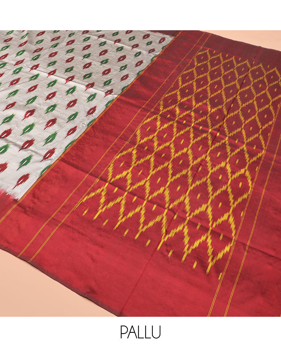 Grey Ikkat Silk Saree Adorned with Ikkat Buttas, Featuring a Contrast Plain Border, Complemented by a Pallu Ikkat Woven in an Ogee Pattern