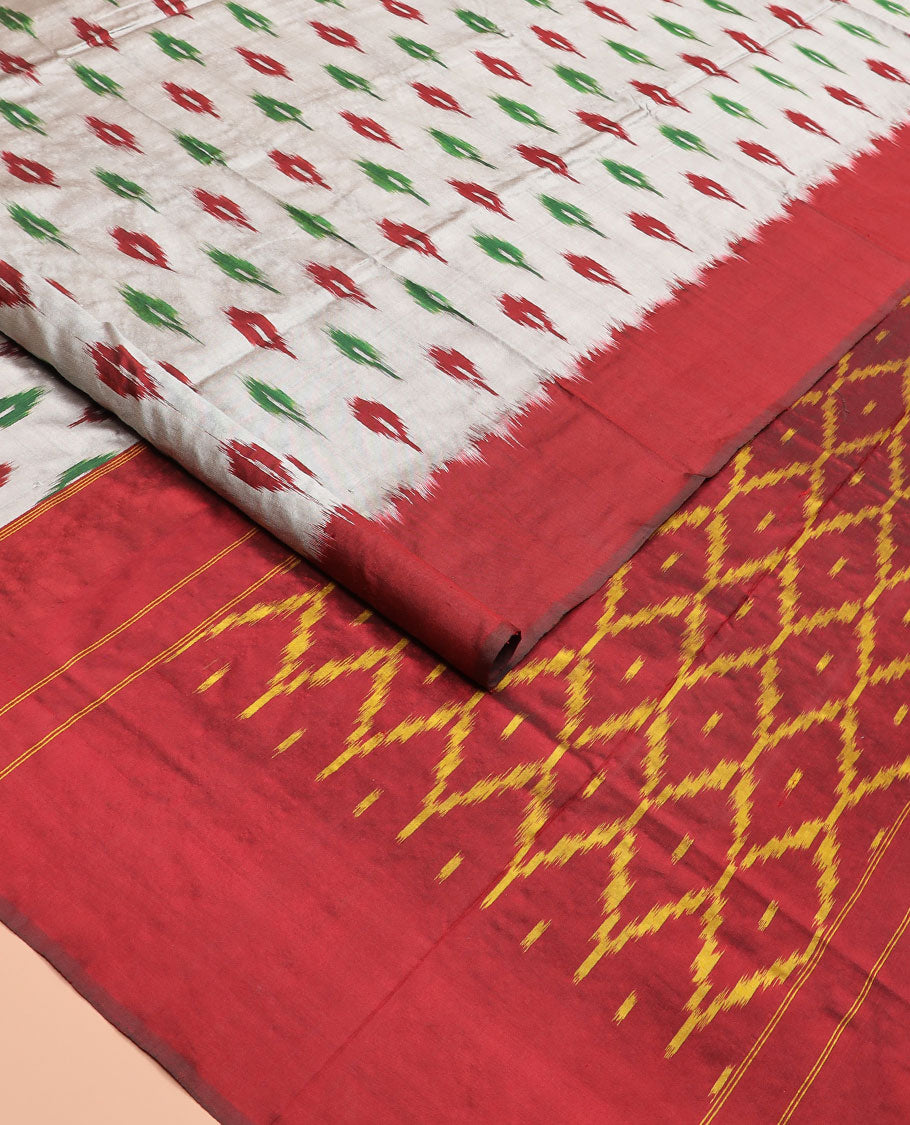 Grey Ikkat Silk Saree Adorned with Ikkat Buttas, Featuring a Contrast Plain Border, Complemented by a Pallu Ikkat Woven in an Ogee Pattern