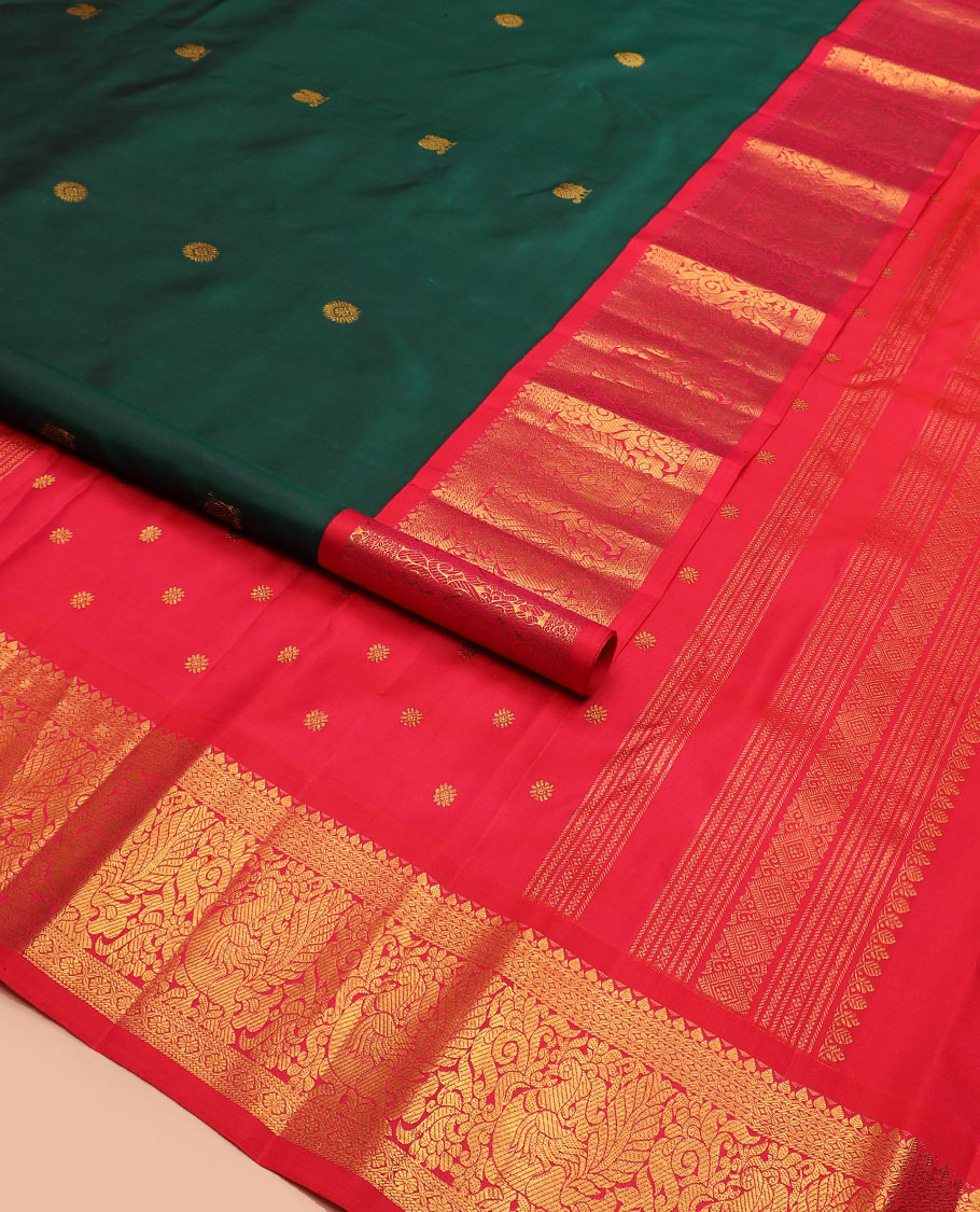Green mayil chakram buttas Kanchipuram silk saree, contrast border of thilakam mokku, cross kamalam, and mayil designs, and zari design pallu