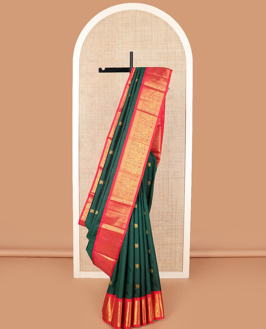 Green mayil chakram buttas Kanchipuram silk saree, contrast border of thilakam mokku, cross kamalam, and mayil designs, and zari design pallu