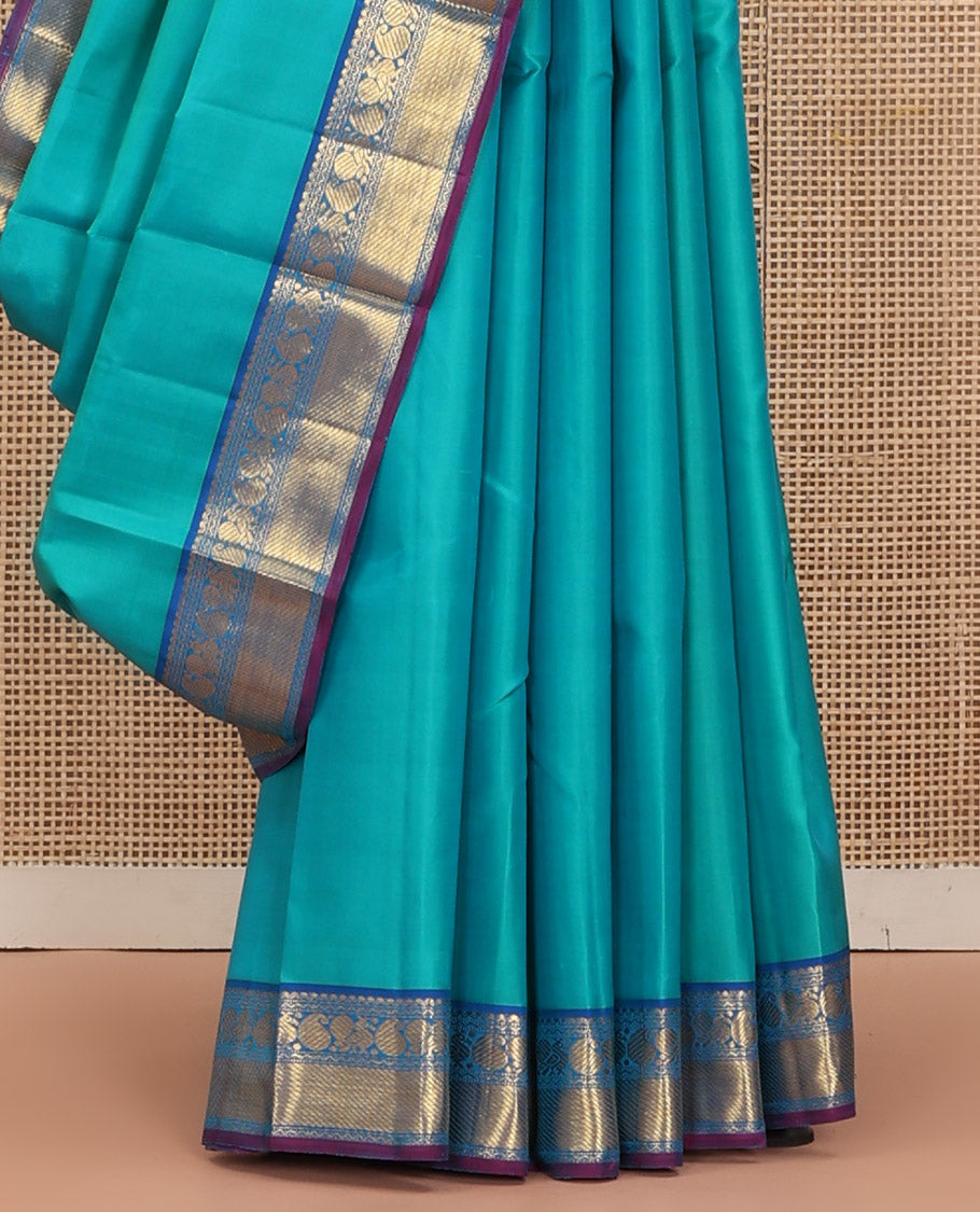 Blue Plain Kanchipuram Silk Saree, Complemented by Contrast Border of Salngai, Muthu, Rekku, Manga, Mayil, and Zari Stripes, Subtly Sparkled Pallu, and Paired with a Contrast Blouse