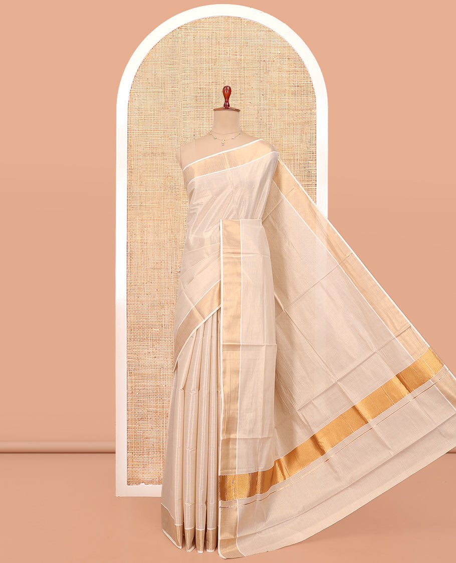 Cream Plain Kerala Cotton Saree, a Zari Bavanji Border, a Self-Pallu, and Paired with a Matching Blouse