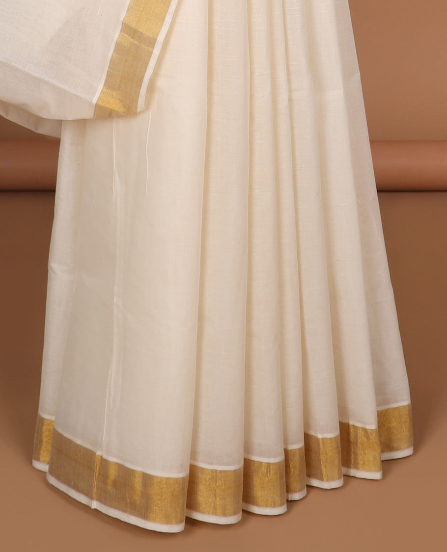 Cream kerala saree with zari designs, zari border & pallu of peacock designs