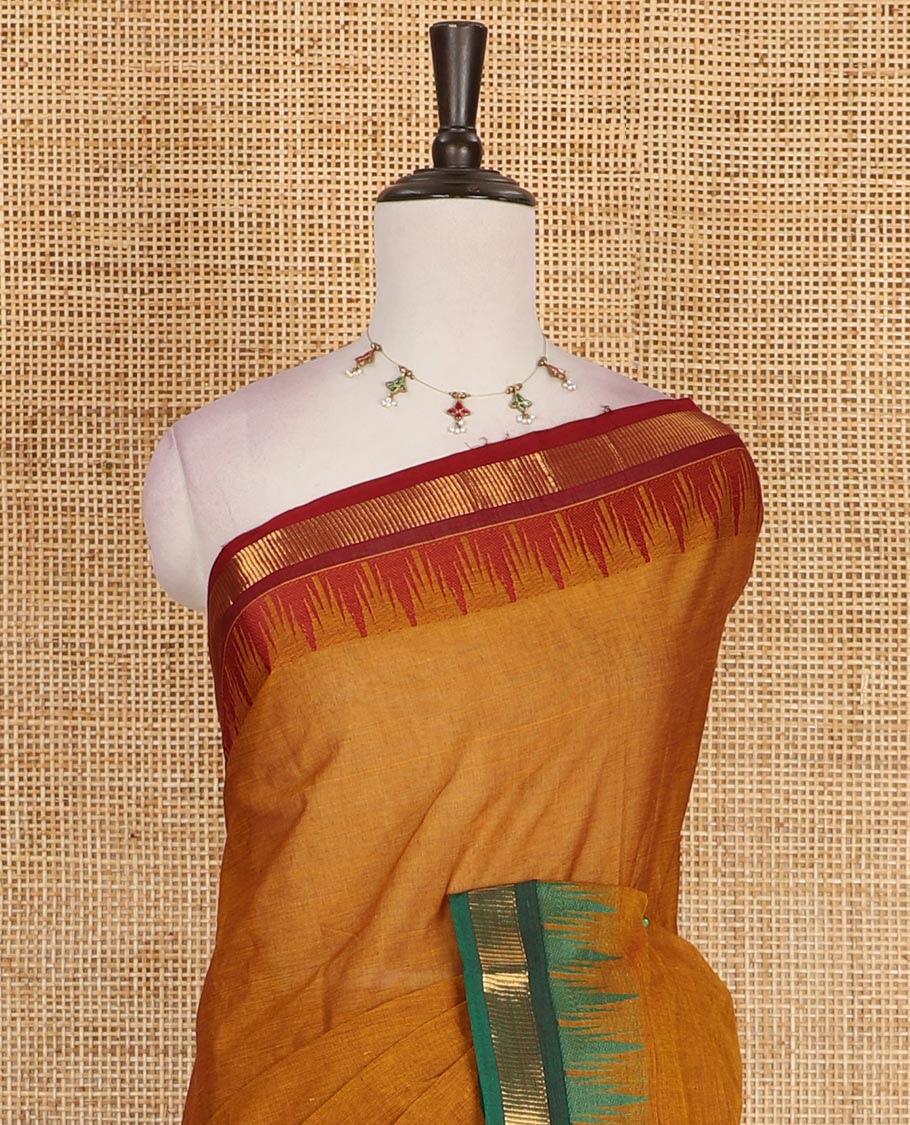 Mustard plain Chettinad cotton saree, contrast ganga jamuna temple zari border, striped pallu, and plain blouse