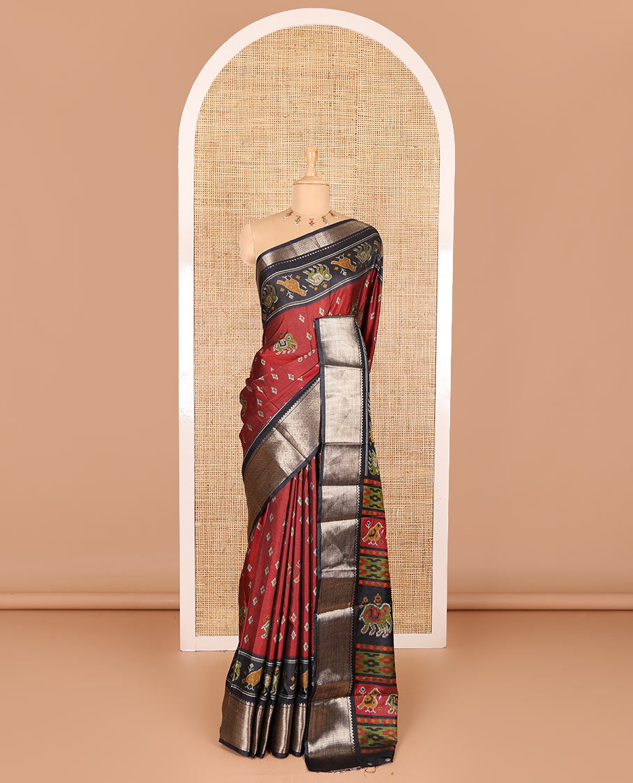 Maroon patola elephant motifs printed Dola silk saree, contrast zari border, and pallu of animal patola motifs print, and a contrast butta printed blouse