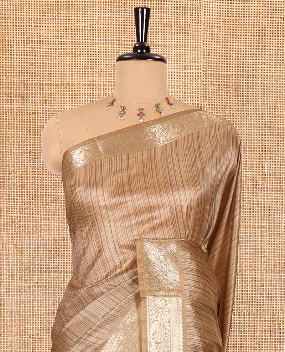 Chikku striped semi-tussar saree, traditional zari border of floral creeper designs, contrast pallu of Pichwai cow print, and contrast Pichwai cow printed blouse