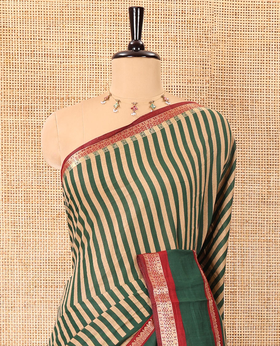 Green vertically striped muslin silk saree, contrast zari rettai pettu border, kalamkari floral vine printed pallu, and a contrast plain blouse