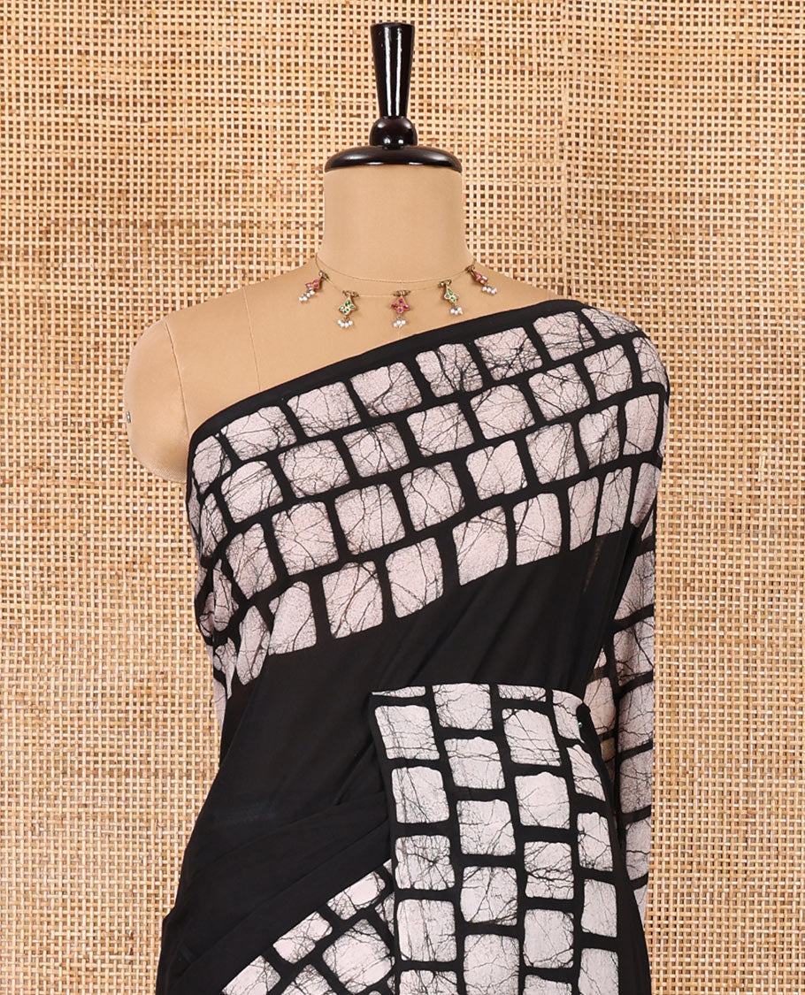 Black plain mul cotton saree, batik style checks printed border, contrast batik printed pallu, and a contrast batik printed blouse