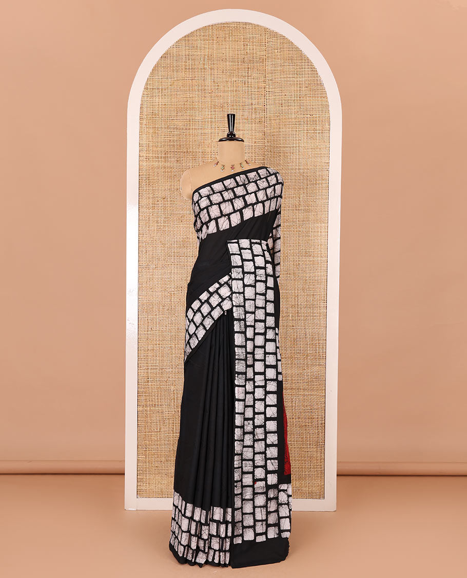 Black plain mul cotton saree, batik style checks printed border, contrast batik printed pallu, and a contrast batik printed blouse