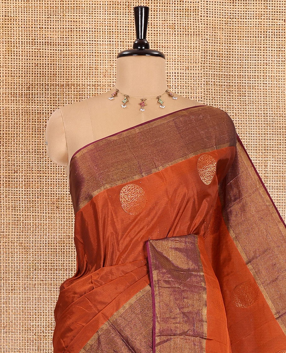 Rust orange semi-soft silk saree with dobby-style buttas and round buttas, contrast zari border, pallu adorned with big round buttas, and a matching blouse