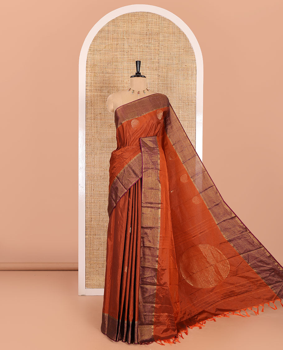 Rust orange semi-soft silk saree with dobby-style buttas and round buttas, contrast zari border, pallu adorned with big round buttas, and a matching blouse
