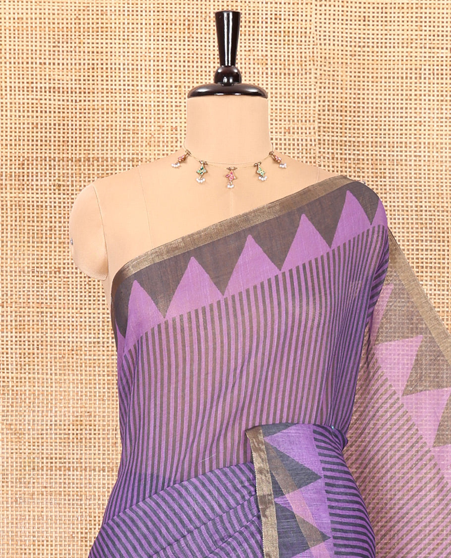 Lavender vertical stripes printed linen cotton saree, a temple-printed border, big polka dot printed pallu, and a printed blouse