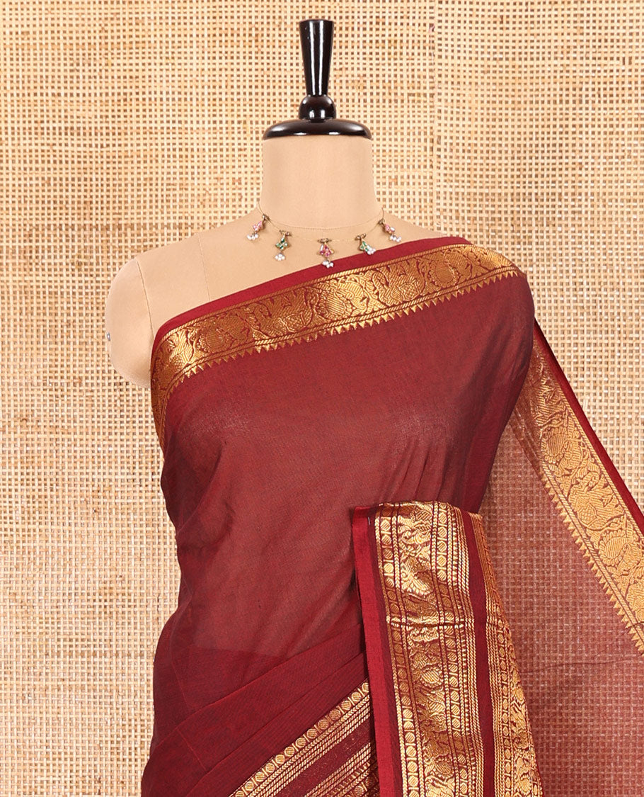 Maroon Plain Chettinad Cotton Saree Accentuated with a Gleaming Zari Rettai Pettu Border Featuring Elephant and Peacock Motifs, Subtly Striped Pallu, and Paired with a Matching Blouse