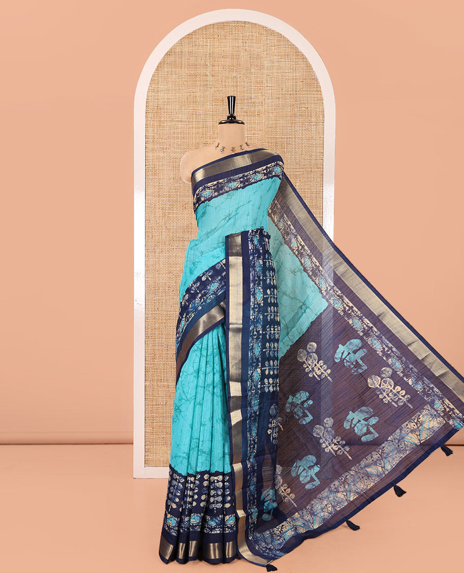 Rama Green Linen Cotton Saree, Adorned with Shibori Printed All Over Its Body, Complemented by a Contrast Batik Printed Zari Border, Floral Printed Pallu, and Paired with a Contrast Blouse