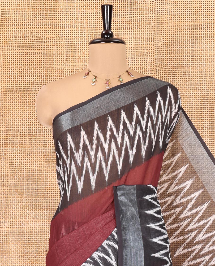 Maroon Plain Linen Cotton Saree, Complemented by a Contrast Ikkat-Style Chevron Striped Border, Chevron Design Pallu, and Paired with a Contrast Blouse