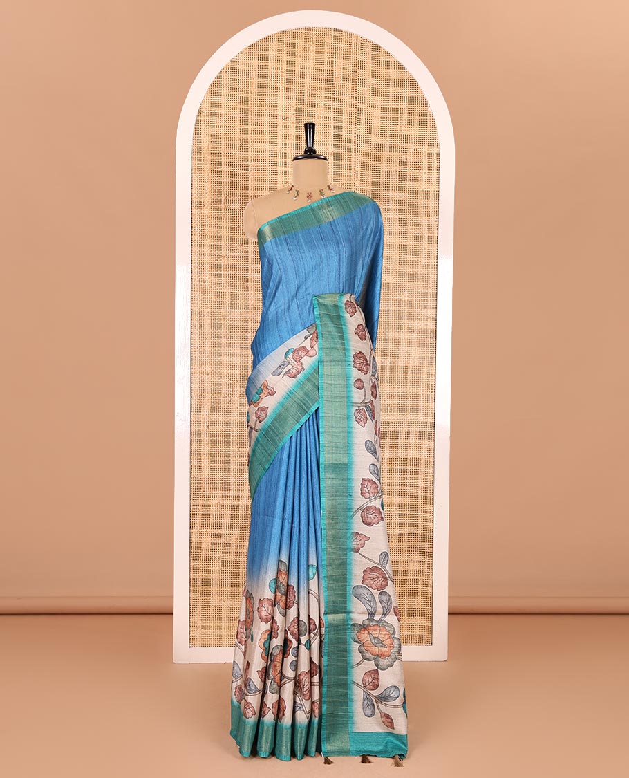 Blue plain fancy tussar saree, contrast floral printed border, floral vine printed pallu, and a contrast plain blouse