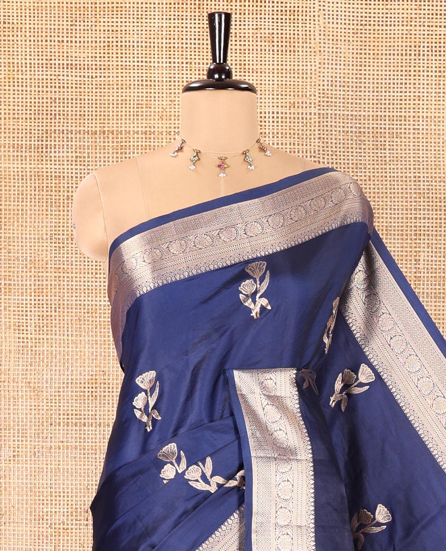 Navy Blue Semi-Banaras Satin Silk Saree, Dazzled with Floral Zari Buttas Across Its Body, Highlighted by Traditional Zari Design Border, Grand Zari Woven Palu of Jaal Designs, and Paired with a Matching Blouse