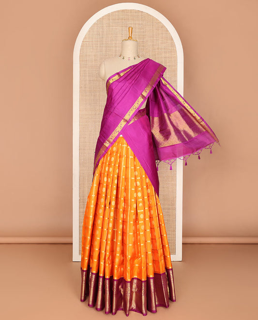 Orange pure-silk half saree, chakram butta enclosed checked skirt, contrast border & blouse of banaras,mayil kann & kodi visiry & intricate dhavani