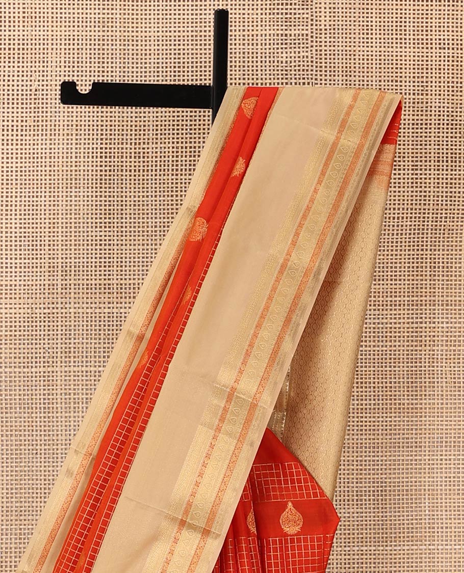 Orange zari checks and buttas Vasundhara silk mix saree, contrast rettai pettu border of thilakam mokku, muthu, cross neli, poun, ara madaam, and mayil designs, and then kuli kann pallu