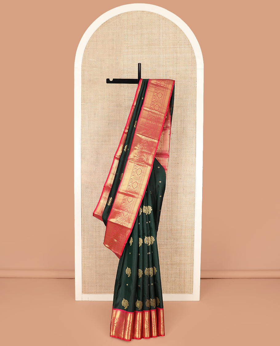 Green Vasundhara Silk Saree Decorated with Zari Buttas, Complemented by a Contrast Border of Rekku, Mayil Kann, Cross Kamalam, Laddu Kamalam, Rudraksham, Rettai Neli, Muthu, and Mayil Kann, Grandly Woven Jaal Pallu, and Paired with a Contrast Blouse
