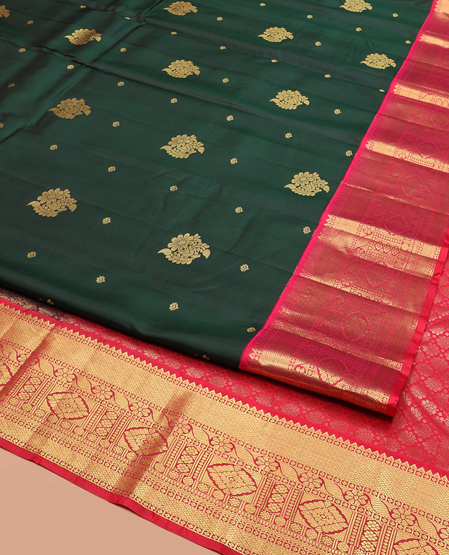 Green Vasundhara Silk Saree Decorated with Zari Buttas, Complemented by a Contrast Border of Rekku, Mayil Kann, Cross Kamalam, Laddu Kamalam, Rudraksham, Rettai Neli, Muthu, and Mayil Kann, Grandly Woven Jaal Pallu, and Paired with a Contrast Blouse