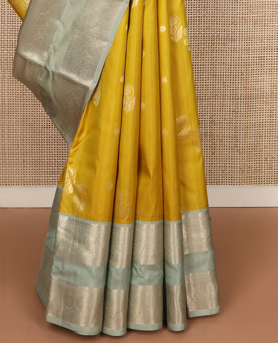 Yellow zari buttas silk saree, contrast rettai pettu border of thilakam,manga,banaras,poun & kodi visiry & floral design pallu