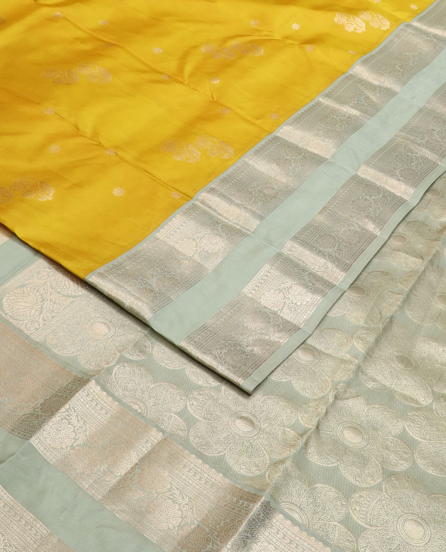 Yellow zari buttas silk saree, contrast rettai pettu border of thilakam,manga,banaras,poun & kodi visiry & floral design pallu