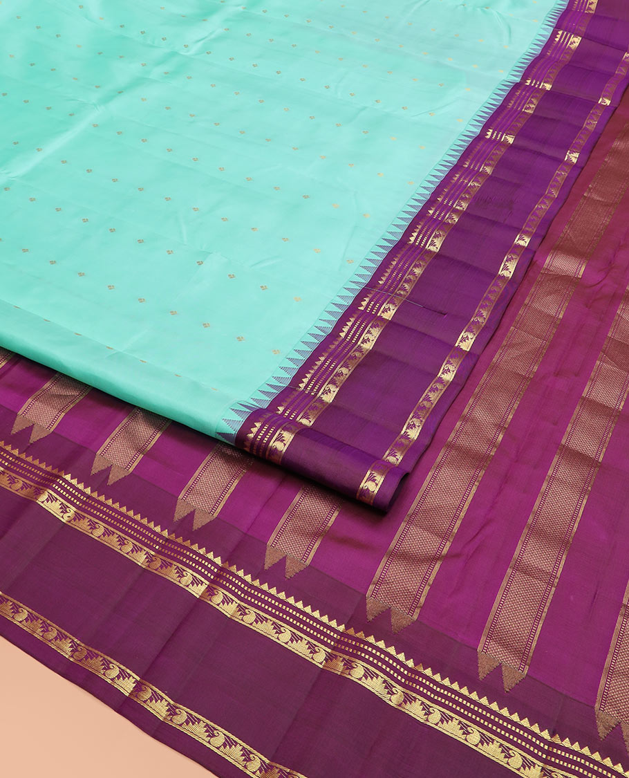 Blue Vasundhara Silk Saree Mesmerized with Zari Buttas, Complemented by a Contrast Border of Thazampoo Rekku, Muthu, and Manga Designs, Subtly Sparkled Zari Woven Pallu, and a Contrast Blouse