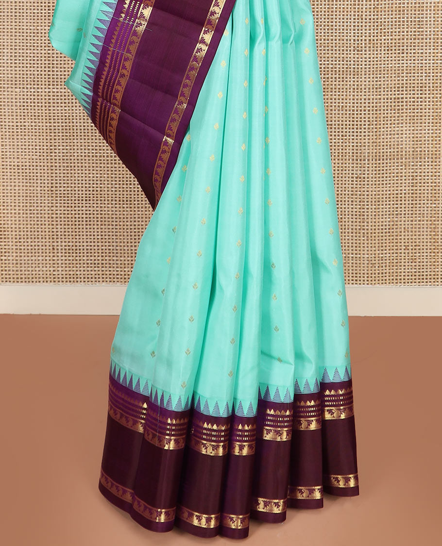 Blue Vasundhara Silk Saree Mesmerized with Zari Buttas, Complemented by a Contrast Border of Thazampoo Rekku, Muthu, and Manga Designs, Subtly Sparkled Zari Woven Pallu, and a Contrast Blouse