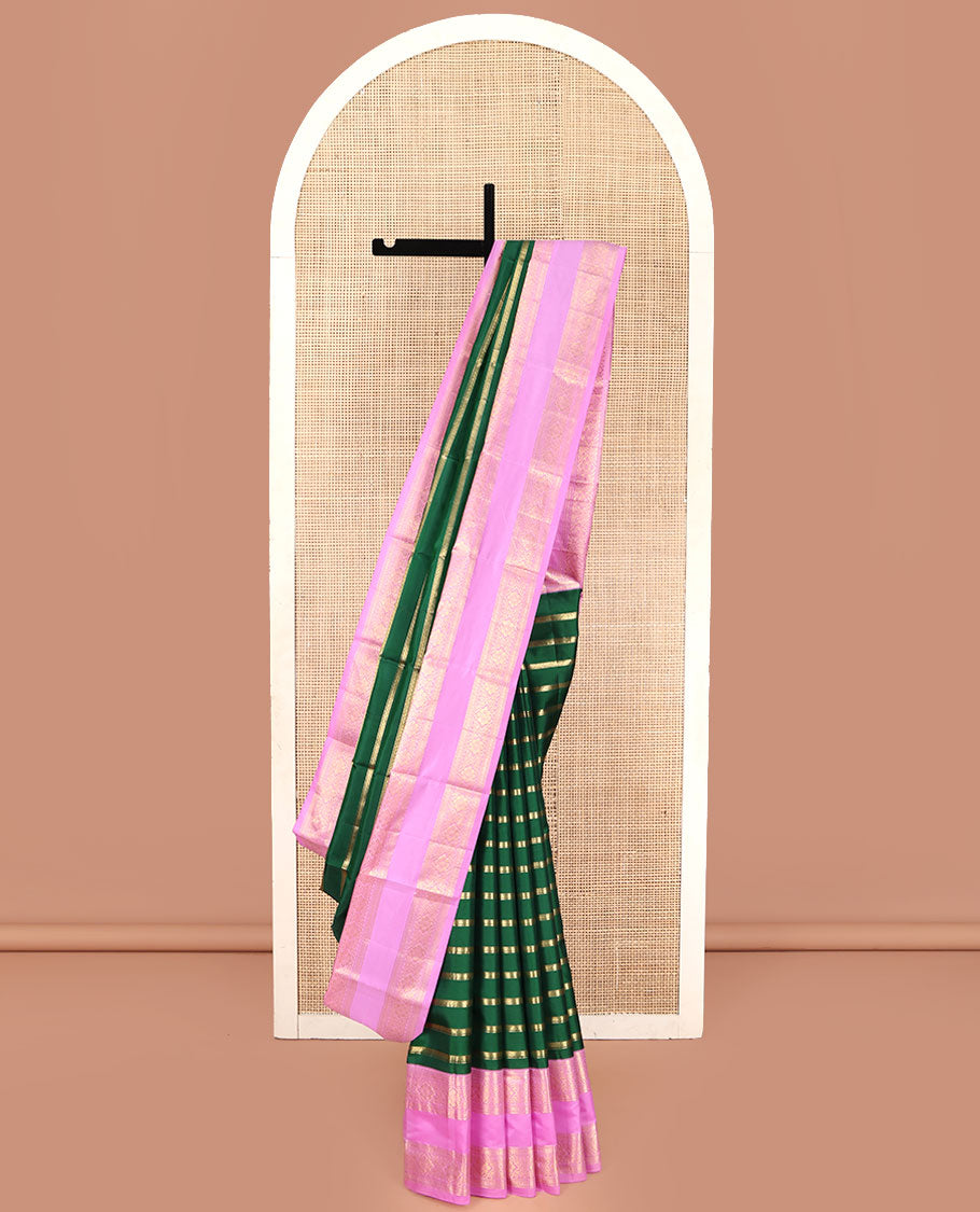 Green Vasundhara Silk Saree, Gracefully Embellished with Zari Stripes All Over Its Body, Complemented by Contrast Rettai Pettu Traditional Zari Design Border, Intricately Designed Pallu, and Paired with a Contrast Blouse