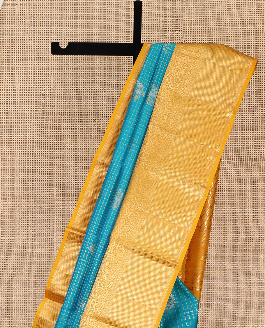 Blue Vasundhara Silk Saree, Masterfully Woven with Zari Buttas and Zari Checks All Over Its Body, Complemented by a Contrast Border of Traditional Designs, Grandly Woven Jaal Pallu, and Paired with a Contrast Blouse