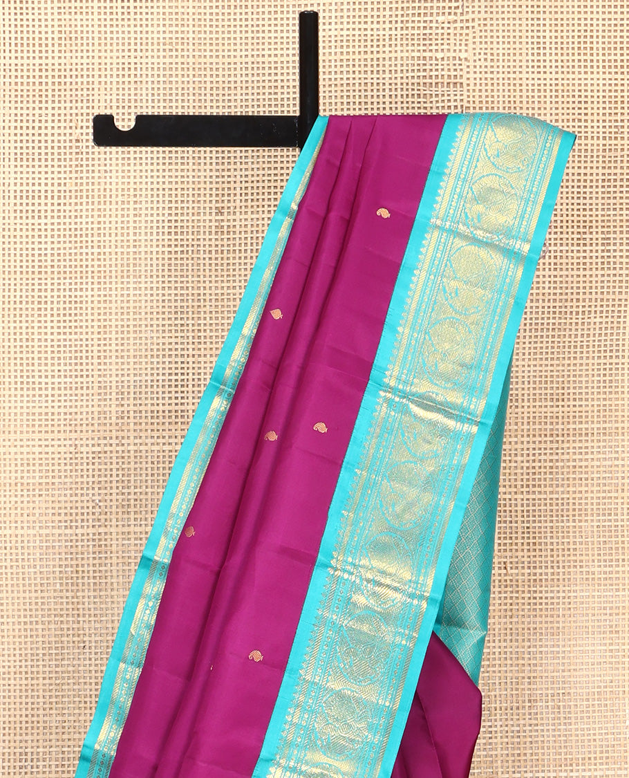 Purple Vasundhara Silk Saree, Subtly Sparkled With Zari Buttas All Over Its Body, Complemented by Zari Buttas All Over Its Body, Complemented by Contrast Border of Thilakam, Banaras, and Mayil Designs Grand Jaal Pallu and Paired with a Contrast Blouse
