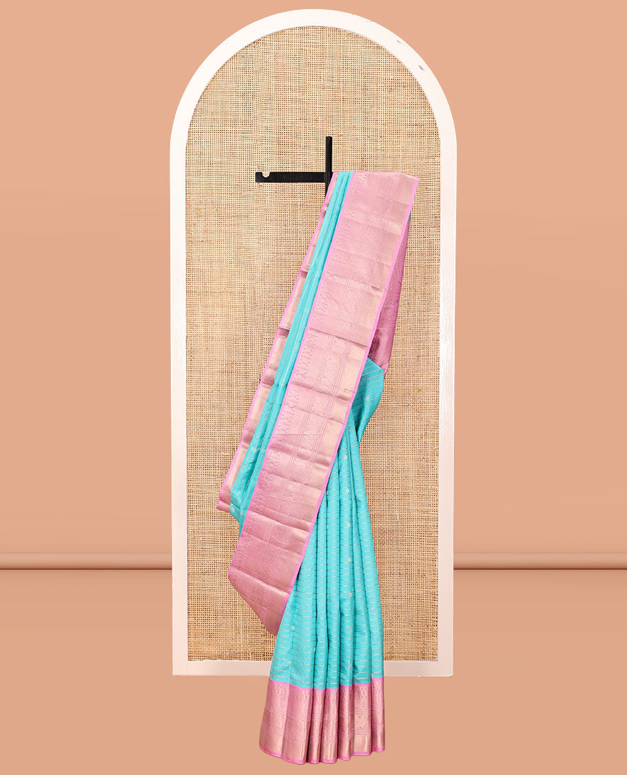 Blue Vasundhara Silk Saree, Sparsely Sparkled with Zari Stripes and Buttas, Contrast Border of Muthu, Kamalam, Mayil, Poun, Ara Maadam, and Mayil Designs, Grand Pallu, and a Contrast Blouse