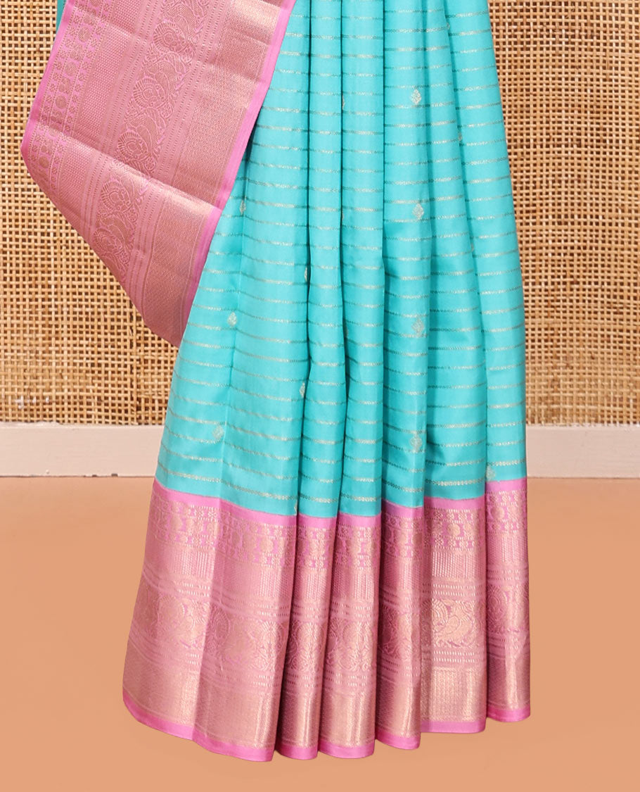 Blue Vasundhara Silk Saree, Sparsely Sparkled with Zari Stripes and Buttas, Contrast Border of Muthu, Kamalam, Mayil, Poun, Ara Maadam, and Mayil Designs, Grand Pallu, and a Contrast Blouse
