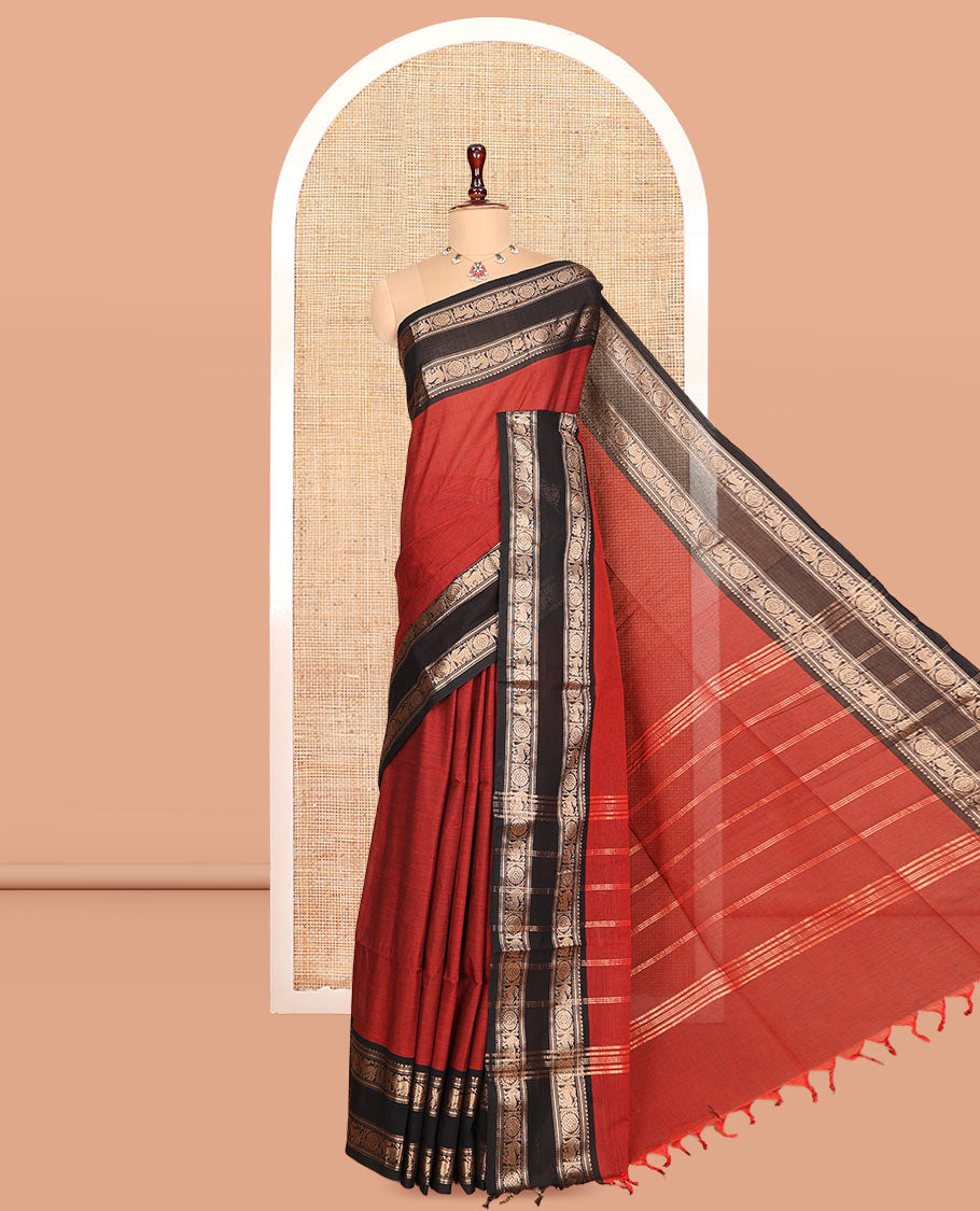 Brick Red Plain Chettinad Cotton Saree, Complemented by a Contrast Yaali-Chakram Zari Border, Striped Pallu, and a Matching Blouse