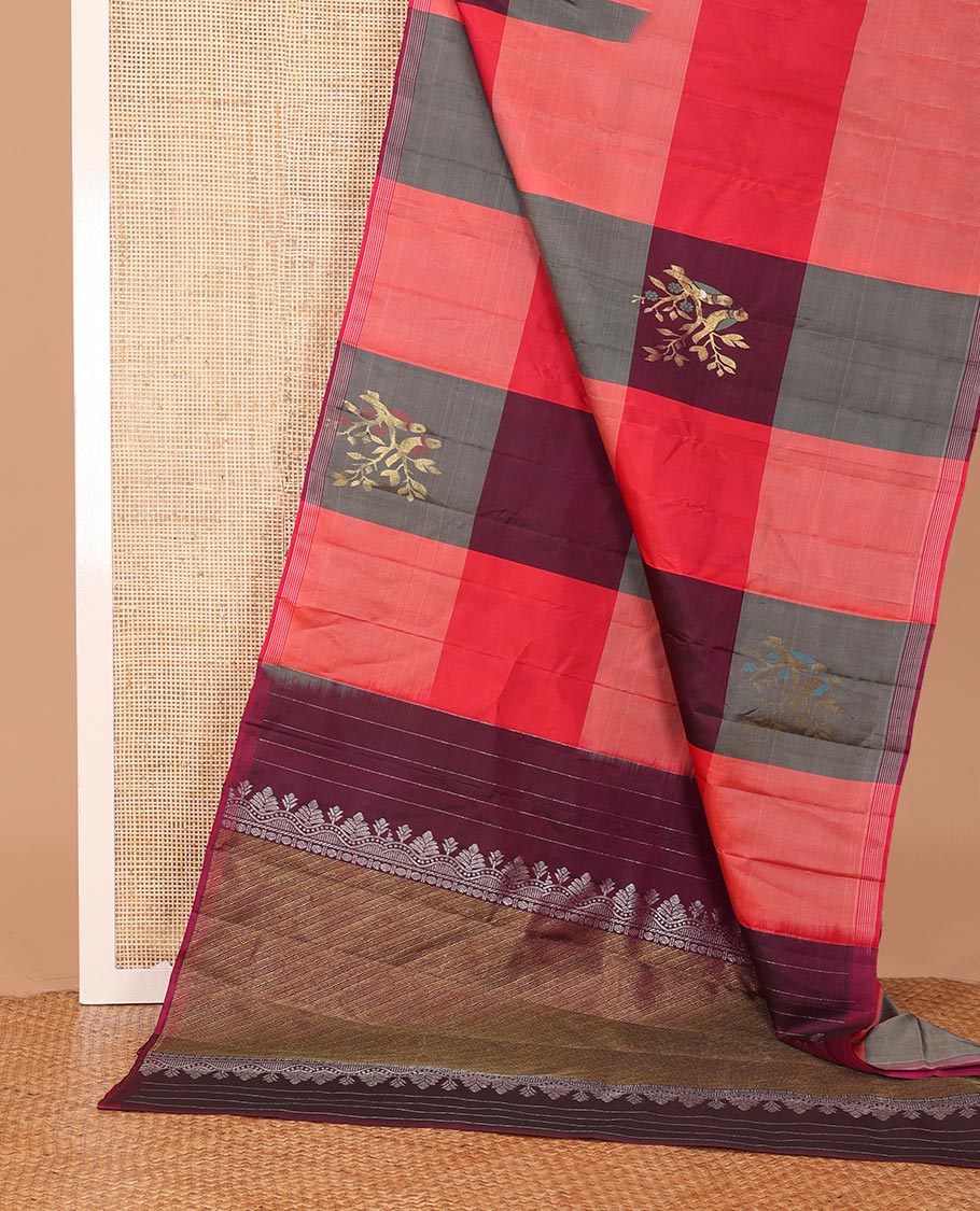 Multi-colored bird buttas enclosed checked Kanchipuram silk saree, striped piping border, and zari-rich pallu