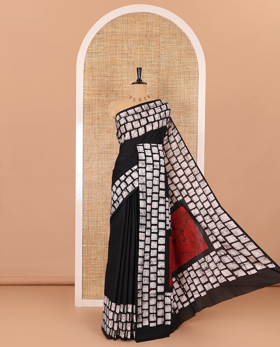 Black plain mul cotton saree, batik style checks printed border, contrast batik printed pallu, and a contrast batik printed blouse